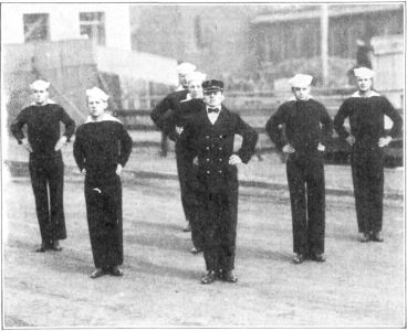 FIG. 2.&mdash;HIPS

The position called "Hips" is that of "Attention" with the hands placed
on the hips, the fingers forward and the thumbs back, at the same time
keeping the shoulders and elbows well back.