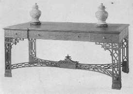 These copies of rare old pieces of furniture are of the
best. The choice of wood, the carving, the inlay, all show the highest
ideals. The Chinese Chippendale table shows the pagoda effect, and the
Hepplewhite desk has the charm of a secret drawer.