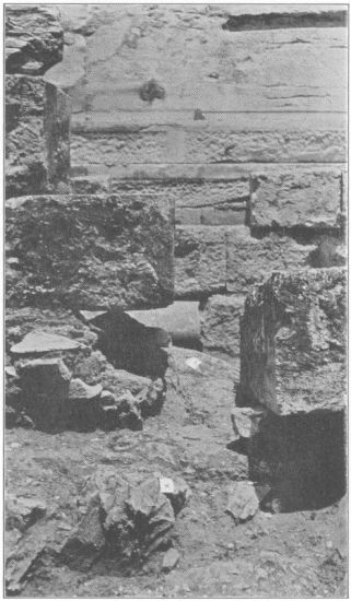 Figure 9

Looking north in the line of the eastern interior cross-wall. A view
showing the orthostate which was in contact with the interior wall and
the rough surface (X) of the native rock in the line of the latter
